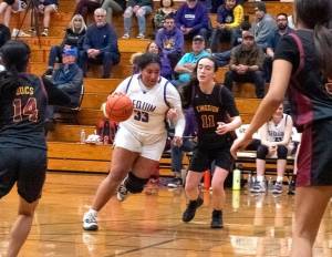 Sequim's Jelissa Julmist (33) drives the lane against Kingston on Friday night. Sequim won the game 72-28 to improve to 16-0 on the season. (Emily Matthiessen/Olympic Peninsula News Group)