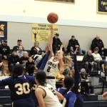 Lonnie Archibald/for Peninsula Daily News
Forks Kadie Wood scores over a host of Chief Leschi Warriors during the Spartans 76-25 win Wednesday night.