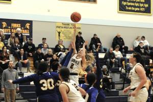 Forks Kadie Wood scores over a host of Chief Leschi Warriors during the Spartans 76-25 win Wednesday night. (Lonnie Archibald/for Peninsula Daily News)