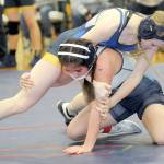 Forks Miley Blanton, top, takes on Grace Odun of River Ridge in the 119-pound class during the Battle for the Axe last month at Port Angeles High School. (Keith Thorpe/Peninsula Daily News)