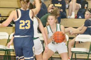 Port Angeles' Kennedy Rognlien, gets around a pick set by a teammate against Bainbridge's Sierra Berry (23) on Saturday in Port Angeles. (Dave Logan/for Peninsula Daily News)