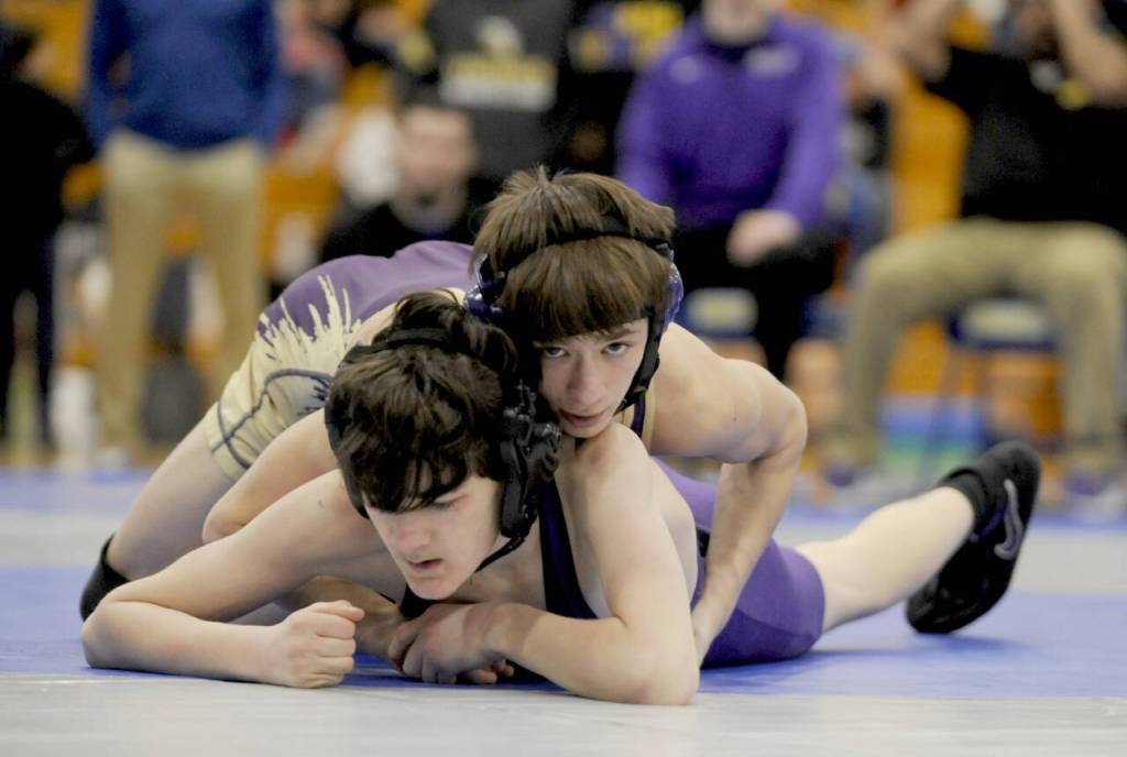 Sequims Cayden Beauregard, top right, takes on North Kitsaps Nolan Hancock at the Olympic League subdistrict tournament in Bremerton on Saturday. Beauregard won the match by technical fall (18-3) and took first place overall at 106 pounds. (Michael Dashiell/Olympic Peninsula News Group)