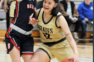 Keith Thorpe/Peninsula Daily News
Peninsula's Adam Kaganak, right, pushes into Bellevue's Sav Huerta during Wednesday's game in Port Angeles.