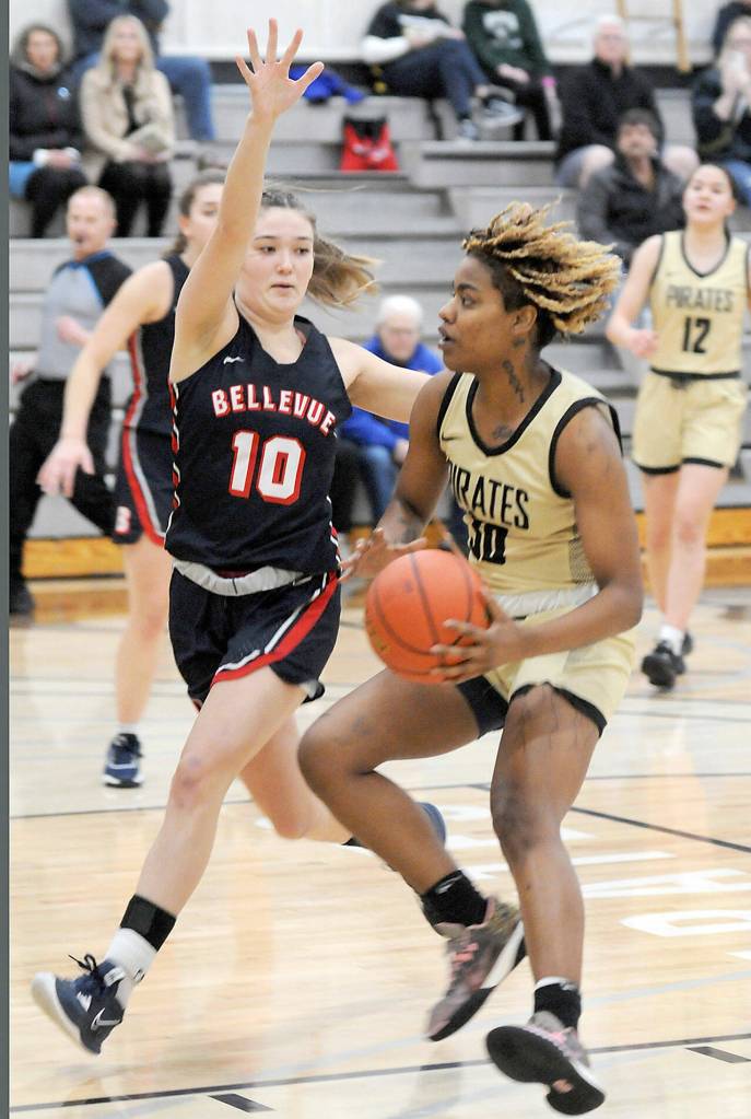 Peninsulas Chasity Selden, right, drives to the lane as Bellevues Jadyn Mueller runs interference on Wednesday night in Port Angeles. (Keith Thorpe/Peninsula Daily News)