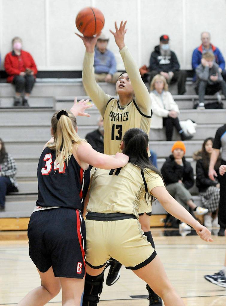 Peninsulas Ituau Tuisaula takes aim at the basket over the heads of Bellevues Kristina Blauman, left, and teammate Jenilee Donovan on Wednesday in Port Angeles. (Keith Thorpe/Peninsula Daily News)
