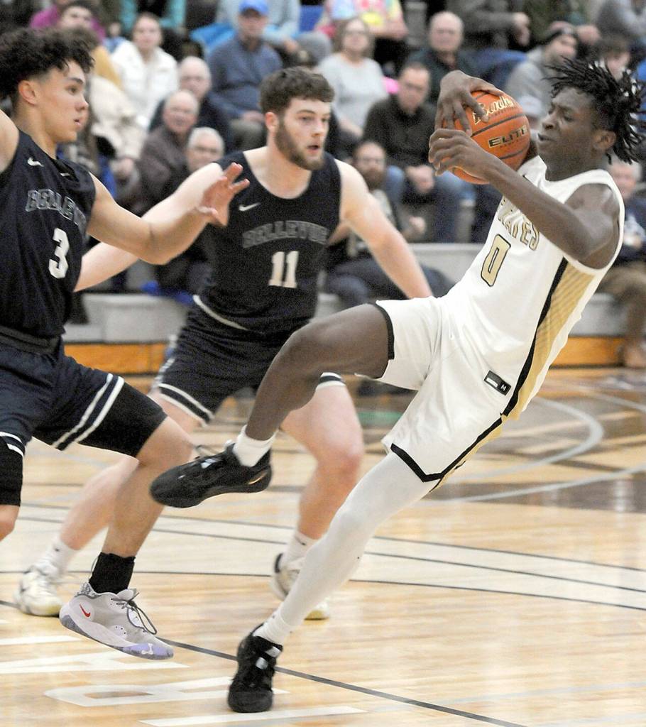 Peninsulas Ese Onakpoma loses his balance at the top of the key as Bellevues Marcus Cole, left, and Ayden Janssan look on during Wednesdays NWAC North Region game in Port Angeles. (Keith Thorpe/Peninsula Daily News)