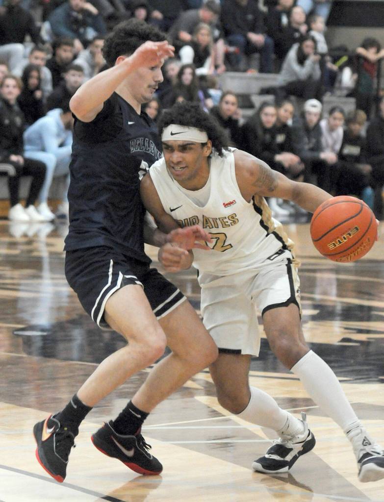 Peninsulas Roosevelt Williams Jr., right, shoulders his way past Bellevues Owen Moriarty during Wednesdays game in Port Angeles. (Keith Thorpe/Peninsula Daily News)