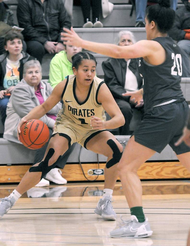 Keith Thorpe/Peninsula Daily News Peninsulas Tatianna Kamae looks for a way around Shorelines Moemanogi Notoa during Saturdays game at Peninsula College in Port Angeles.