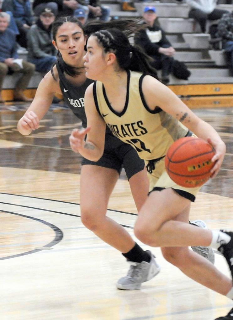 Keith Thorpe/Peninsula Daily News Peninsulas Adam Kaganak, right, slides past Shorelines Taylor Eldredge on Saturday in Port Angeles.