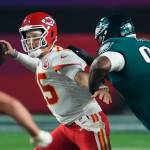 Kansas City Chiefs quarterback Patrick Mahomes (15) passes under pressure from Philadelphia Eagles defensive tackle Jordan Davis (90) during the second half of the NFL Super Bowl 57 football game, Sunday, Feb. 12, 2023, in Glendale, Ariz. (AP Photo/Ross D. Franklin)