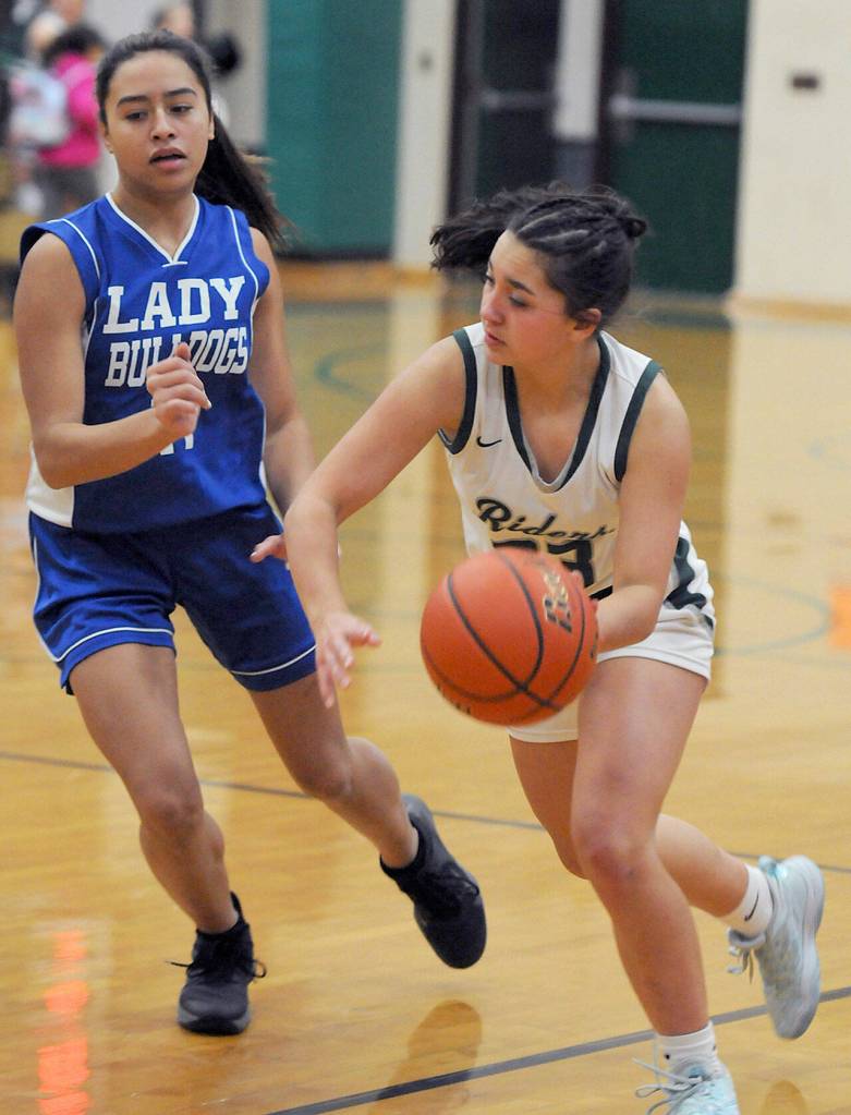 Keith Thorpe/Peninsula Daily News Port Angeles Piper Williams, right, sweeps around North Masons Natalya Garcia during Thursdays district playoff game in Port Angeles.