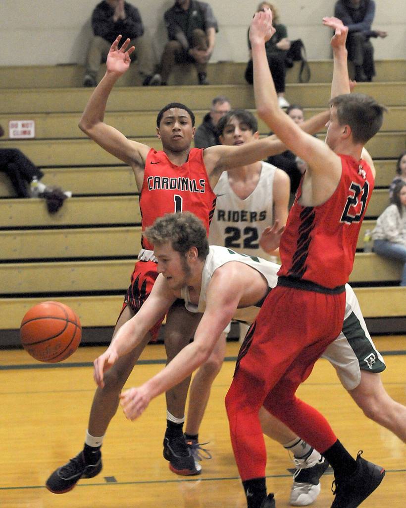 Port Angeles Isaiah Shamp gets squeezed between the defense of Franklin PiercesAmar Coleman, left, and Jordan Disney on Friday at Port Angeles High School. (Keith Thorpe/Peninsula Daily News)