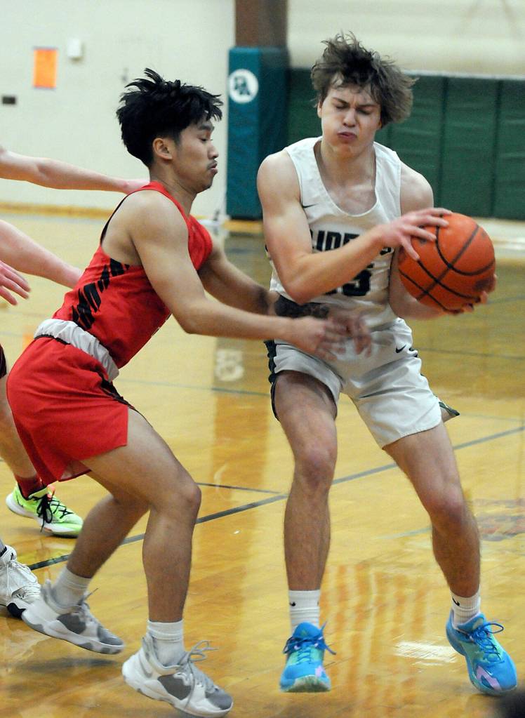 Port Angeles Parker Nickerson, left, fends off the defense of Franklin Pierces Sayvaughn Soeum on Friday night in Port Angeles. (Keith Thorpe/Peninsula Daily News)