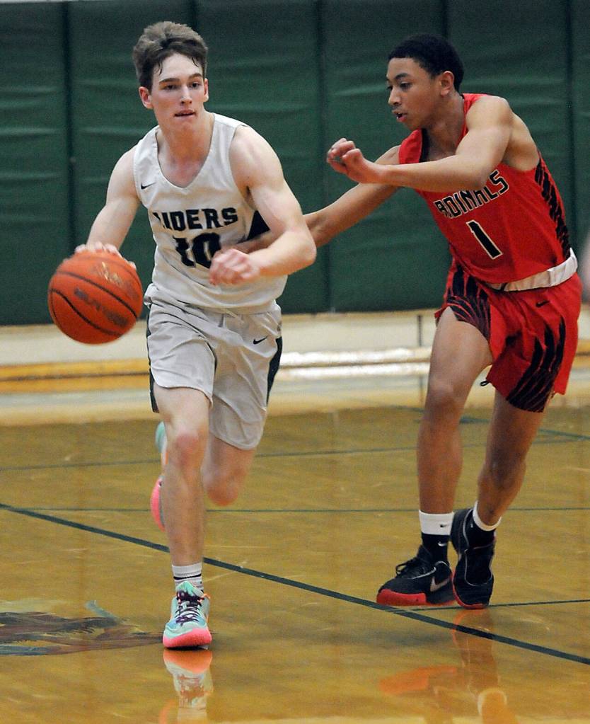 Port Angeles Josiah Long brings the ball downcourt as Franklin Pierces Amaar Coleman keeps pace on Friday at Port Angeles High School. (Keith Thorpe/Peninsula Daily News)