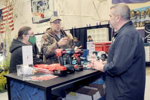 Jack and Marcella Ridge of Sequim talk about power tools with Tony Contestable, tool specialist with Hartnagel Building Supply of Port Angeles, right, during Saturdays 2023 Building, Remodeling & Energy Expo in the Sequim High School gym. The two-day event, hosted by the North Peninsula Building Association, featured a variety of booths, displays and presentations dedicated to home building, repair and remodeling. (Keith Thorpe/Peninsula Daily News)
