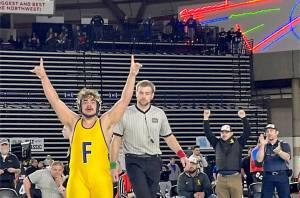 Forks' Sloan Tumaua celebrates after winning the 220-pound 1B/2B state championship at the Mat Classic late Saturday night. (WIAA photo)
