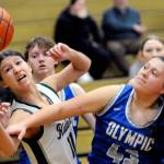 KEITH THORPE/PENINSULA DAILY NEWS
Port Angeles' Lindsay Smith, left, stretches for a rebound as Olympic's Kylee Murphy during a Jan. 20 game in Port Angeles. The Roughriders play in regionals Friday night.