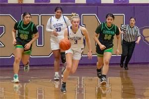 Sequims Jolen Vaara pushes the ball up the court with Jelissa Julmist trailing. The Wolves will play No. 1-ranked Ellensburg in the state regionals Friday night. (Emily Mathiessen/Olympic Peninsula News Group)