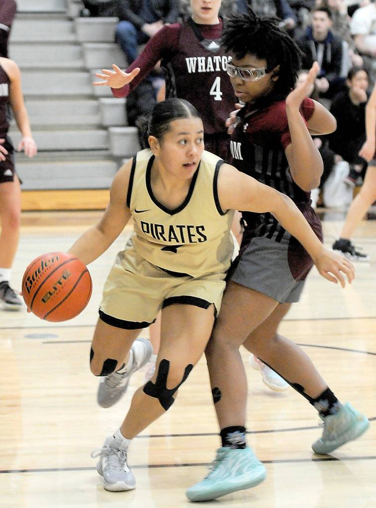 Keith Thorpe/Peninsula Daily News
Peninsula's Tatianna Kamae, left, works her way past Whatcom's Halei Murrell on Wednesday night in Port Angeles.
