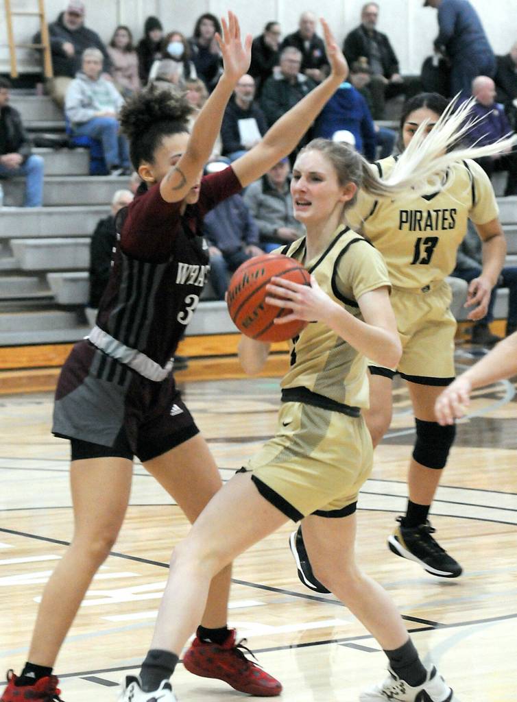 Peninsulas Millie Long, center, works past Whatcoms Neomi Davidson, left, as teammate Ituau Tuisaula looks on at right on Wednesday in Port Angeles. (Keith Thorpe/Peninsula Daily News)