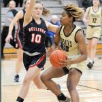 Peninsulas Chasity Selden, right, drives to the lane as Bellevues Jadyn Mueller plays defense Feb. 8 in Port Angeles. (Keith Thorpe/Peninsula Daily News)