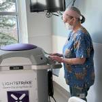 Janine Kirby, EVS Tech II, prepares the machine for service. (Jefferson Healthcare)