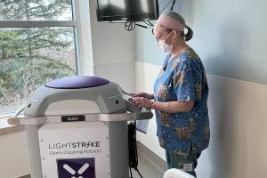 Janine Kirby, EVS Tech II, prepares the machine for service. (Jefferson Healthcare)
