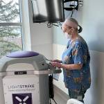 Janine Kirby, EVS Tech II, prepares the machine for service. (Jefferson Healthcare)