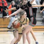 Peninsulas Millie Long squeezes around the defense of Everetts Lilly Frunk during Wednesday nights game at Peninsula College in Port Angeles. (Keith Thorpe/Peninsula Daily News)
