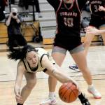 Peninsulas Adam Kaganak reaches low in the lane as Everetts Jayda Pittman tries to defend on Wednesday night in Port Angeles. (Keith Thorpe/Peninsula Daily News)