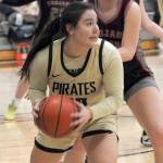 Peninsulas Ruth Moss looks for her teammates as Everetts Grace Trichler tries to hold her off on Wednesday in Port Angeles. (Keith Thorpe/Peninsula Daily News)