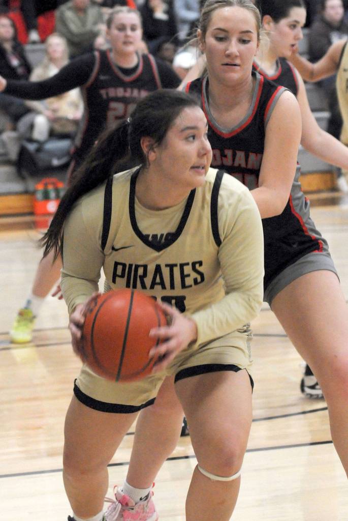 Peninsulas Ruth Moss looks for her teammates as Everetts Grace Trichler tries to hold her off on Wednesday in Port Angeles. (Keith Thorpe/Peninsula Daily News)