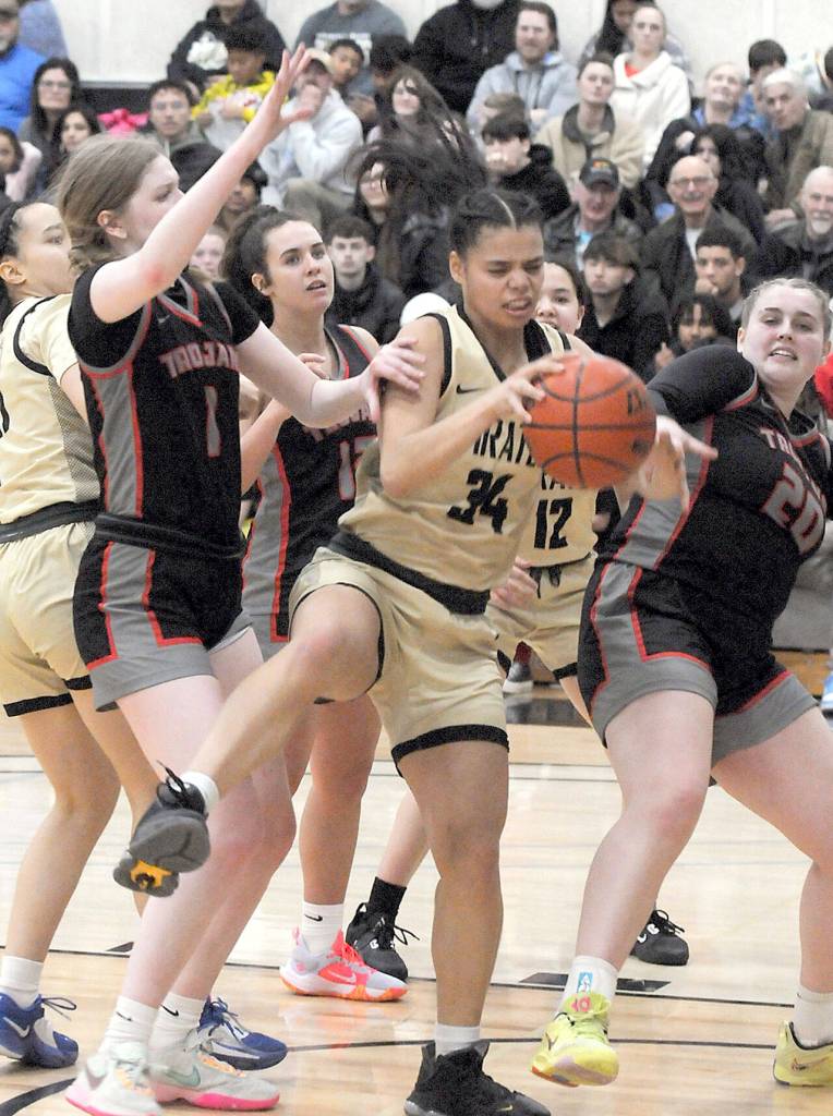 Peninsulas Gina Brown, center, pulls down a rebound surrounded by Everett defenders, from left, Lilly Frunk, Ashlynd Hund and Sophia MacKenzie on Wednesday at Peninsula College. (Keith Thorpe/Peninsula Daily News)