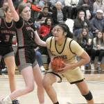 Peninsulas Ituau Tuisaula, right, heads for the paint as Everetts Lilly Frunk tries to hold her off on Wednesday night in Port Angeles. (Keith Thorpe/Peninsula Daily News)
