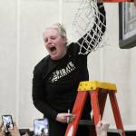 Peninsula Pirates head coach Ali Crumb emits a scream of excitement as she cuts down the net after her team clinched the NWAC North Region championship by defeating Everett on Wednesday in Port Angeles. (Keith Thorpe/Peninsula Daily News)