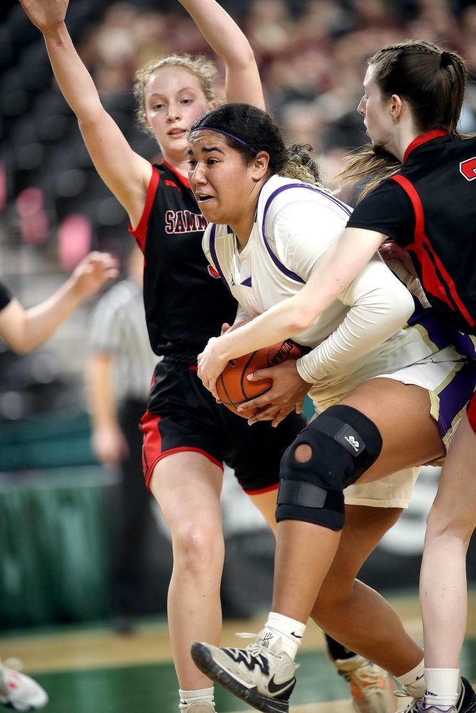 Sequims Jelissa Julmist battles through a Sammamish double team. Julmist finished the game with 15 rebounds and 12 points, doing much of her damage in the second half. (David Willoughby/for Peninsula Daily News)