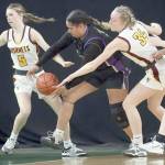 David Willoughby/for Peninsula Daily News Sequims Jelissa Julmist, center, competes for a loose ball with White Rivers Sophie Ross-Soler, left, and Vivian Kingston during the Wolves Class 2A state quarterfinal at the Yakima SunDome on Thursday night.