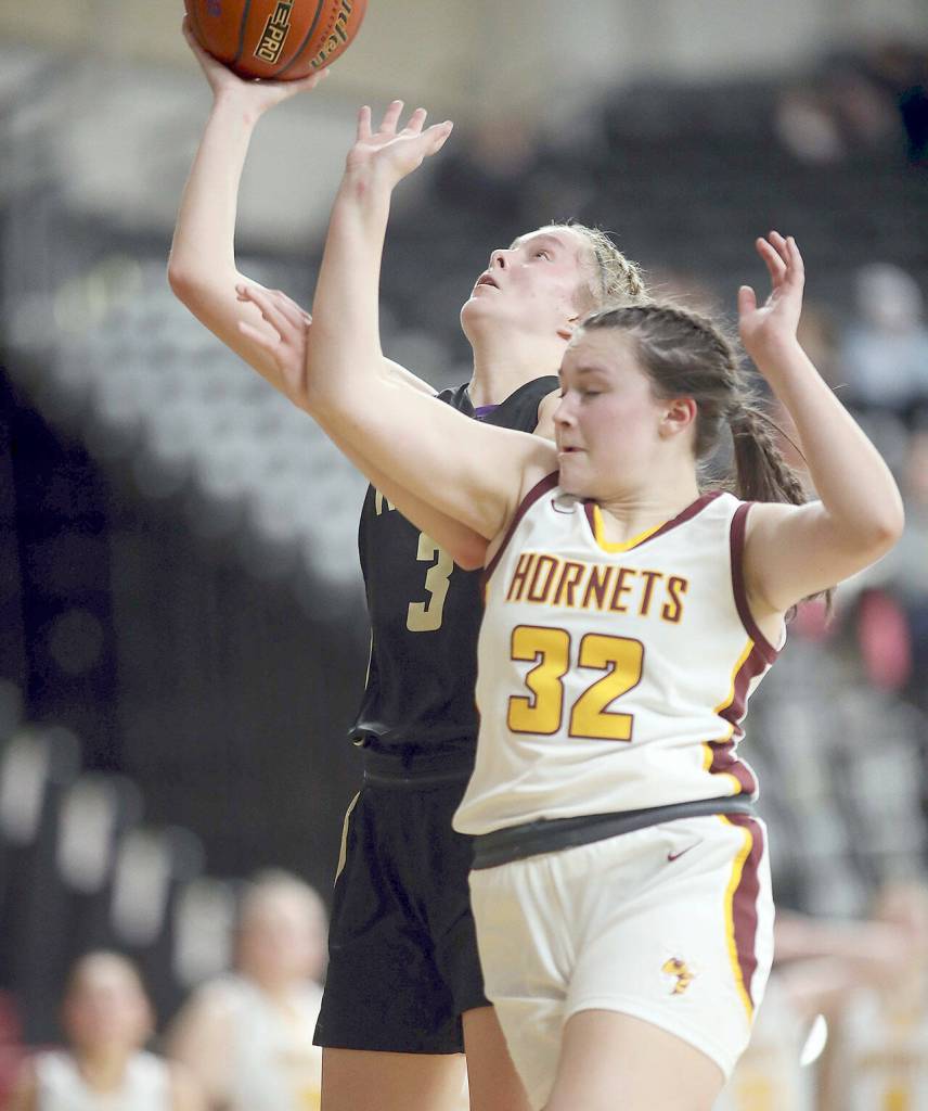 David Willoughby/for Peninsula Daily News Sequims Jolene Vaara puts up a layup while fending off the defense of White Rivers Dakota Sprouse during their Class 2A state quarterfinal at the Yakima SunDome on Thursday night.