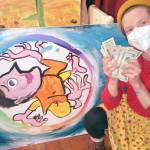 Sarah Tucker 
The 2022 winner, Otto Younker, is pictured with her creation and prize.