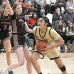 Peninsulas Ituau Tuisaula, right, heads for the paint as Everetts Lilly Frunk tries to hold her off on Wednesday night in Port Angele. (Keith Thorpe/Peninsula Daily News)