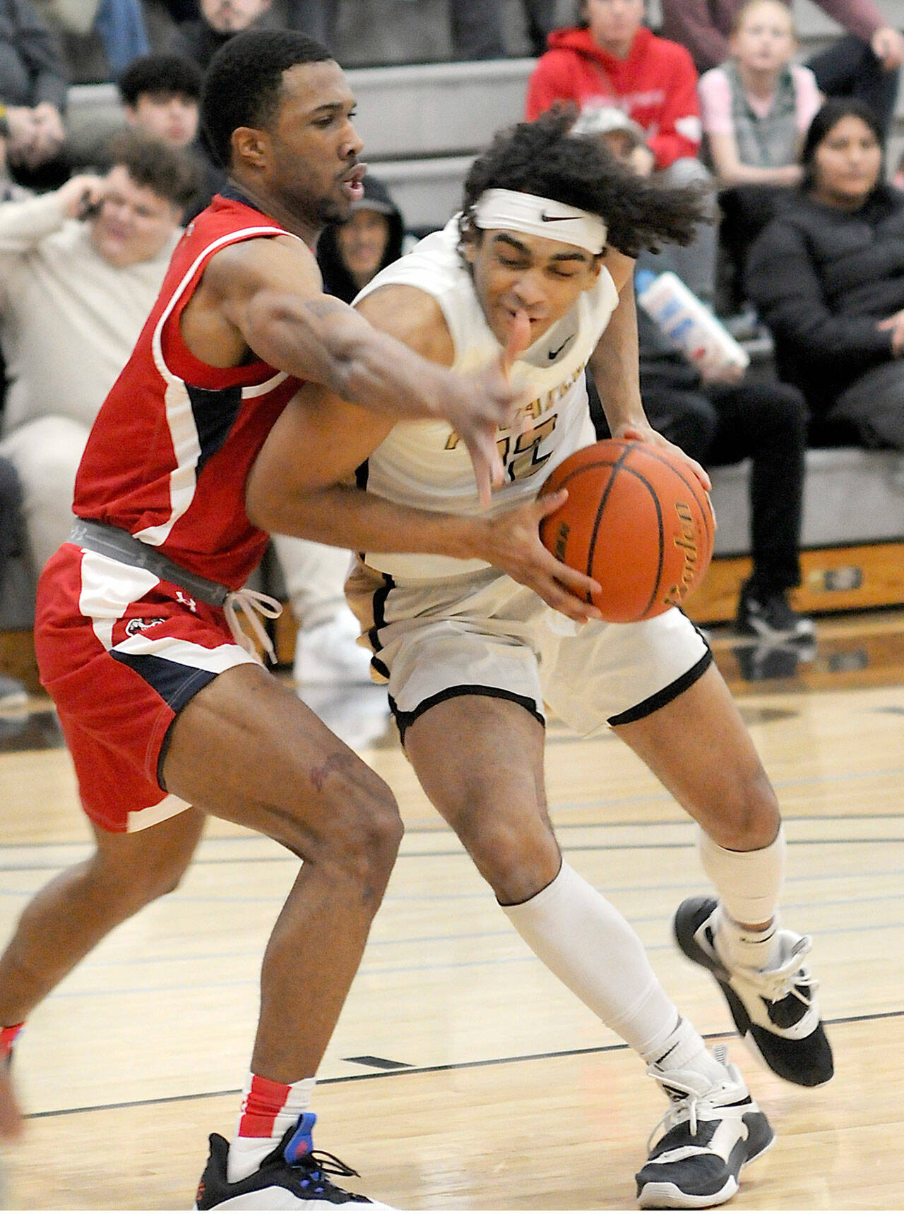 Peninsulas Roosevelt Williams Jr., right, shoulders his way past Skagit Valleys Omari Maulana earlier this season in a North Division game at Peninsula College. (Keith Thorpe/Peninsula Daily News)