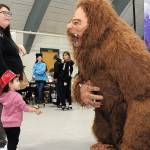 Annalise Sanchez, 2, along with her mother, Yvonne Bolstron of Port Angeles, look in awe at Sasquatch, portrayed by Jess Grello, an organizer of the annual Squatchcon comic and arts convention, during Saturdays Kiwanis KidsFest and Clallam County Community Safety Day in and around Vern Burton Community Center in Port Angeles. The free event brought together a variety of organizations and agencies to promote parenting and community awareness. (Keith Thorpe/Peninsula Daily News)