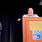 Cynthia Malane, left, accepts the Olympic Leader of the Year award on behalf of her late husband, Ryan Malane, during the Clallam Economic Development Councils annual gala on Friday night at 7 Cedars Casino. At the podium is Jeremy Weist, plant manager for Port Angeles Hardwood, which was the award sponsor. (Peggy Simmons/Clallam Economic Development Council)