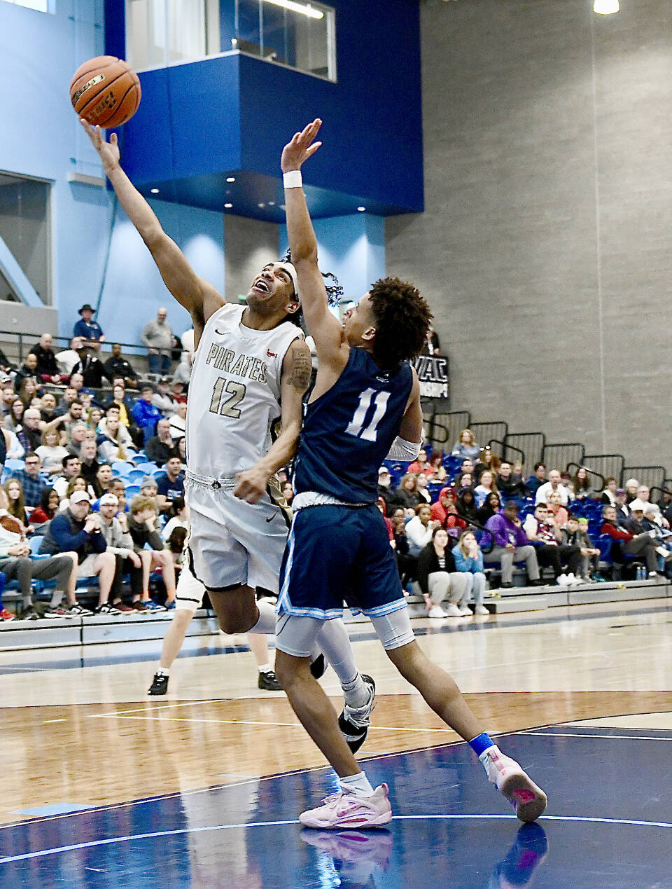 Peninsula Colleges Roosevelt Williams Jr. goes up for a layup around Columbia Basins TaVeus Randle on Saturday in the NWAC tournament held in Pasco. Peninsula lost 77-73. (Jay Cline/Peninsula College)