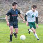 East Jeffersons Isaac Gurney, left, dribbles the ball against Port Angeles Keane McClain at Memorial Stadium in Port Townsend on Saturday. Port Angeles won 7-0. (Steve Mullensky/for Peninsula Daily News)