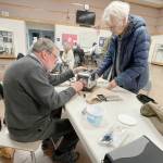 Dave Ehnesbusake, left, takes apart Gwen Howards toaster to find out why the lever on her toaster wouldnt stay down at the Port Townsend Marine Science Centers Repair Cafe on March 11. The culprit was a crumb that prevented an electromagnet inside the toaster from locking the lever into position. (Paula Hunt/Peninsula Daily News)