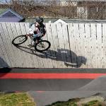 KEITH THORPE/PENINSULA DAILY NEWS
Mason Wilcox-Olton, 8, of Port Angeles casts a shadow on a high-banked curve at the Port Angeles Pump Track at Erickson Playfield on Wednesday. The track, the largest of its type in the Northwest, caters to a wide variety of wheeled conveyances and the first in the country to have an adaptive track element.