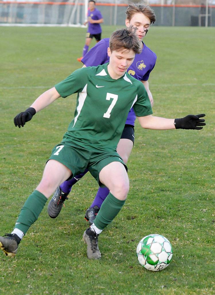 KEITH THORPE/PENINSULA DAILY NEWS Port Angeles Kaleb Gagnon, front, gets ahead of Sequims James Mason during Thursdays match in Port Angeles.