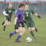 KEITH THORPE/PENINSULA DAILY NEWS Sequims Finn Braaten, center, looks for a way past Port Angeles Kaleb Gagnon, right, as teammate Zak Alton comes up from behind on Thursday night in Port Angeles.