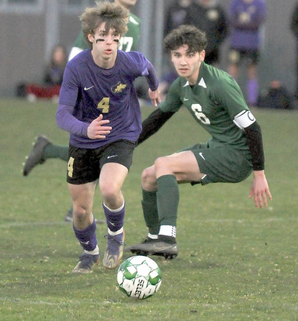 KEITH THORPE/PENINSULA DAILY NEWS Sequims Lake Barrett, left, and Port Angeles Keane McClain move the ball up the pitch during Thursdays match at Port Angeles Civic Field.